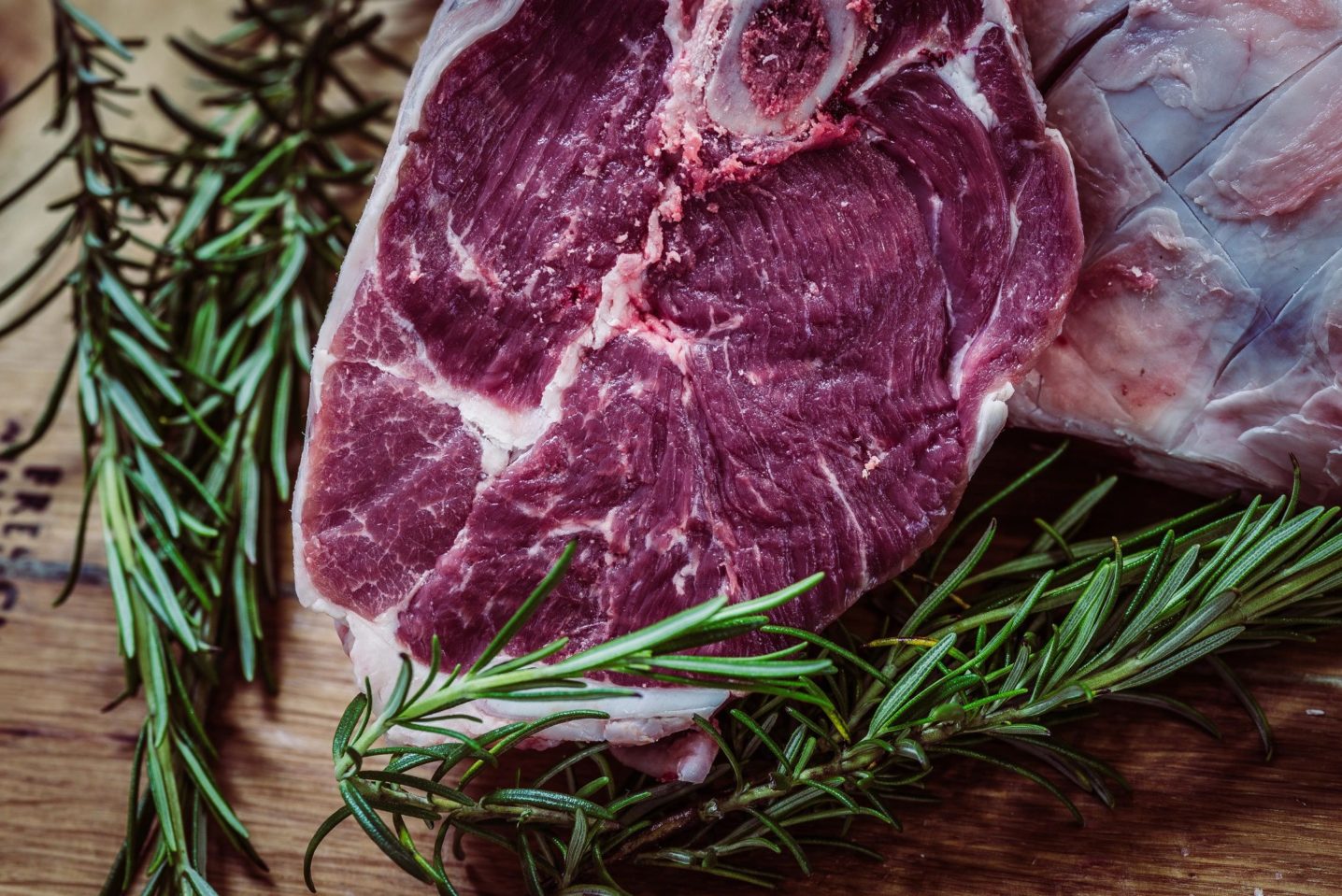 A beautiful piece of red meat surrounded by rosemary